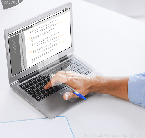 Image of businessman with laptop computer working at office