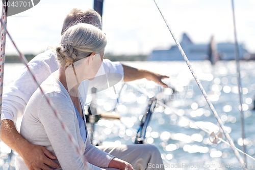 Image of happy senior couple on sail boat or yacht in sea