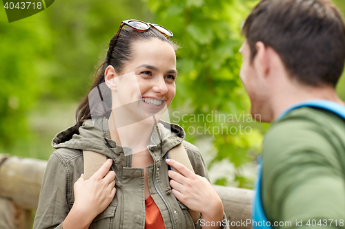 Image of smiling couple with backpacks in nature