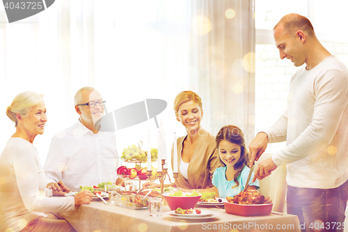 Image of smiling family having holiday dinner at home