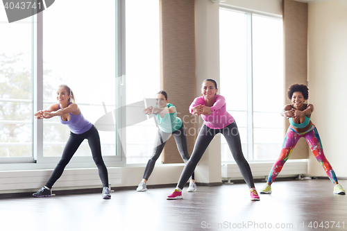 Image of group of happy women working out in gym