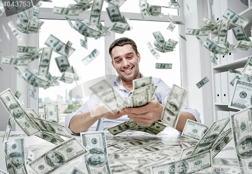 Image of happy businessman with heap of money