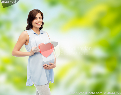 Image of happy pregnant woman with red heart touching belly