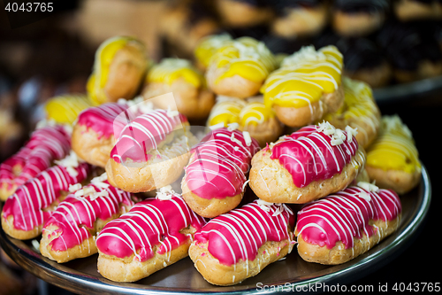 Image of close up of glazed eclair pile on serving tray