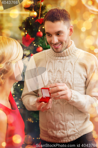 Image of romantic man proposing to a woman