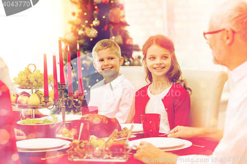 Image of smiling family having holiday dinner at home