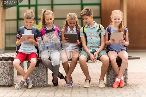 Image of group of happy elementary school students talking