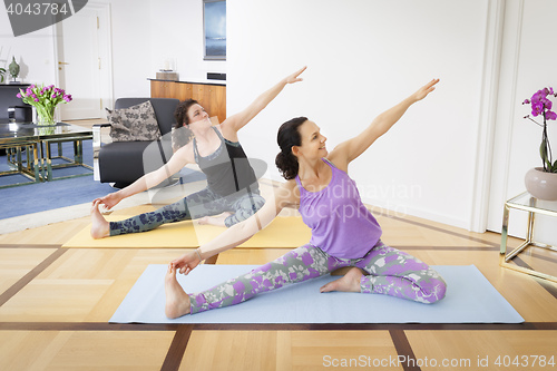 Image of women doing yoga at home