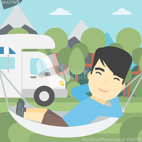 Image of Man lying in hammock in front of motor home.