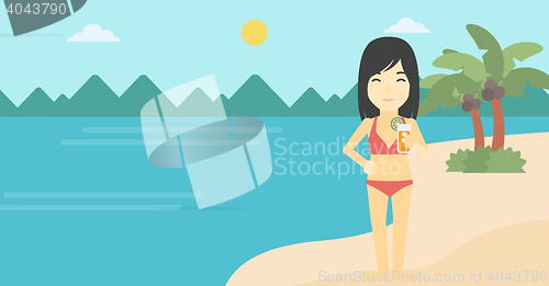 Image of Woman with cocktail on the beach.