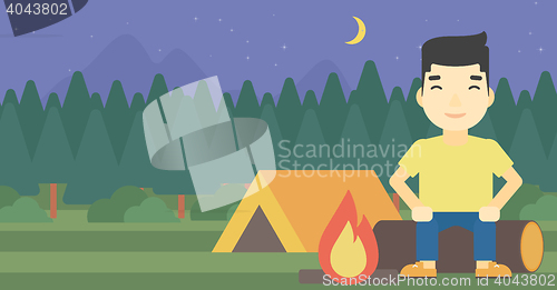 Image of Man sitting on log in the camping.