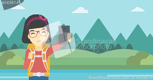 Image of Woman with backpack making selfie.