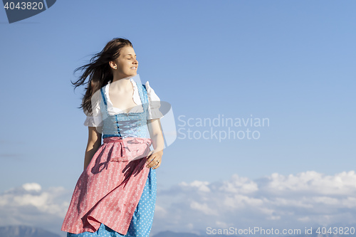 Image of young woman in bavarian traditional dress dirndl