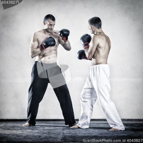 Image of two men fighting boxing sports