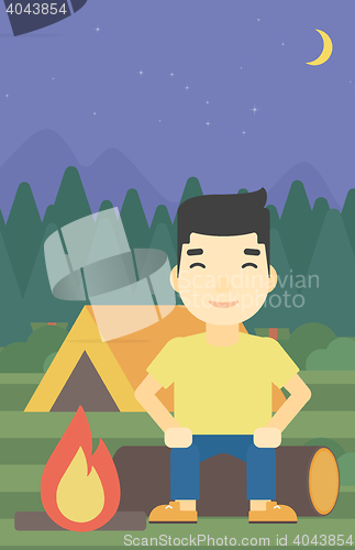 Image of Man sitting on log in the camping.