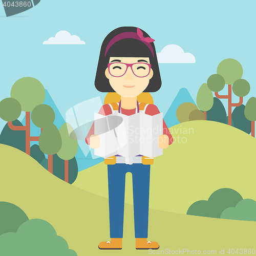 Image of Traveler with backpack looking at map.