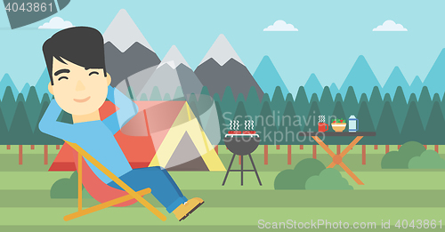 Image of Man sitting in folding chair in the camp.