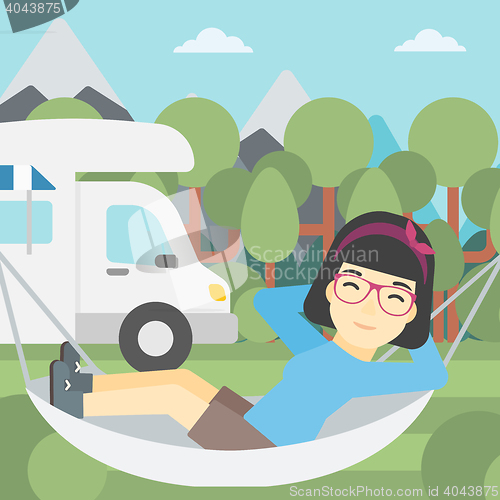 Image of Woman lying in hammock in front of motor home.