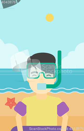 Image of Man with snorkeling equipment on the beach.