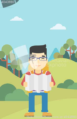 Image of Traveler with backpack looking at map.