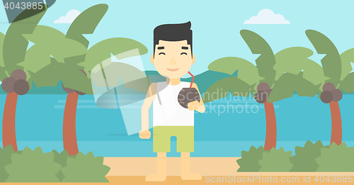 Image of Man drinking coconut cocktail on the beach.