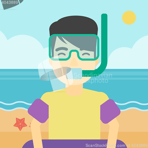 Image of Man with snorkeling equipment on the beach.