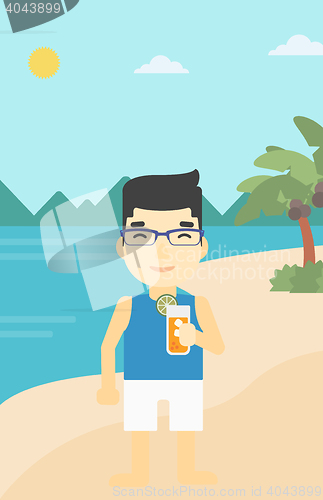 Image of Man with cocktail on the beach.