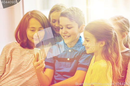 Image of group of school kids taking selfie with smartphone