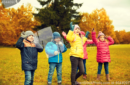 Image of group of happy children having fun in autumn park