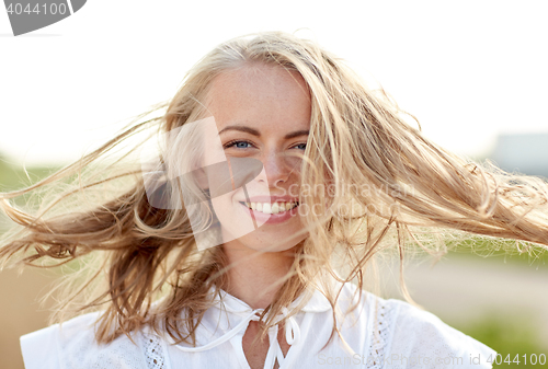 Image of close up of happy young woman in white outdoors
