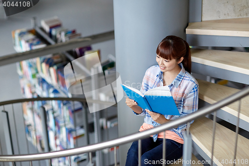 Image of high school student girl reading book at library