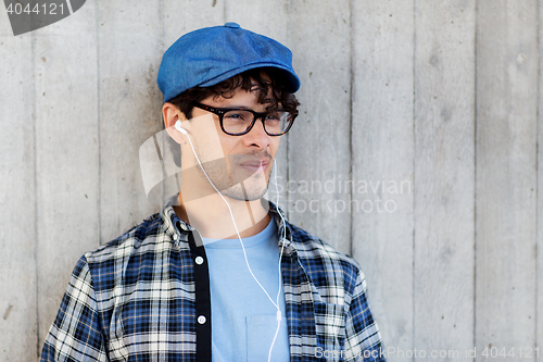 Image of man with earphones listening to music on street