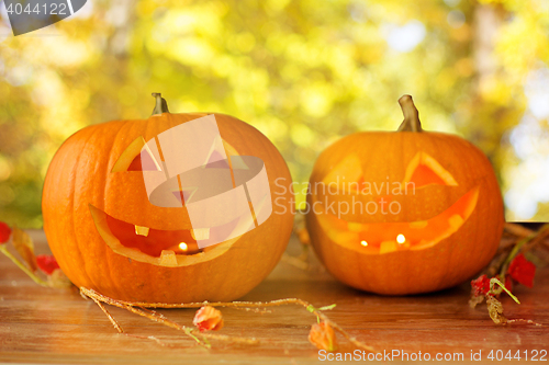Image of close up of pumpkins on wooden table outdoors