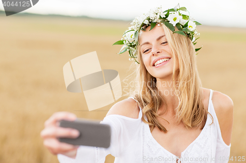 Image of happy young woman taking selfie by smartphone