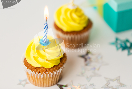 Image of birthday cupcakes with burning candles