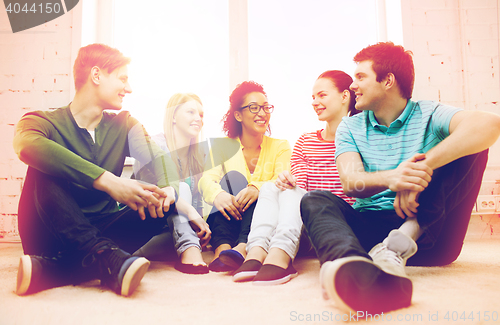 Image of five smiling teenagers having fun at home