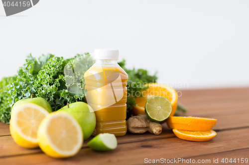 Image of bottle with orange juice, fruits and vegetables