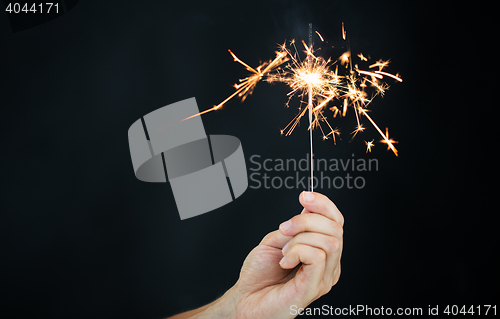 Image of sparkler burning over black background