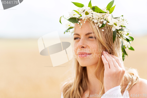 Image of happy woman in wreath of flowers