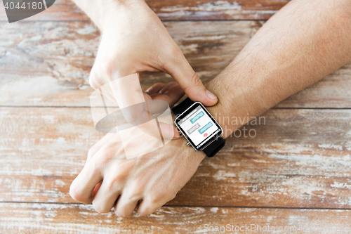 Image of close up of hands with messenger on smart watch