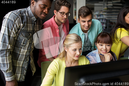 Image of international students with computers at library