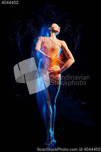 Image of Fine art portrait of beautiful woman dancer in green sparkles