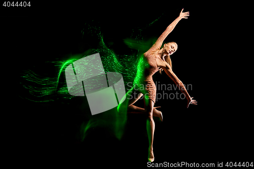 Image of Fine art portrait of beautiful woman dancer in green sparkles