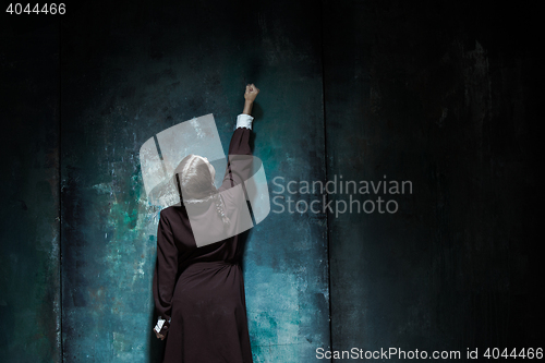 Image of Portrait of a young smiling girl in school uniform as killer woman