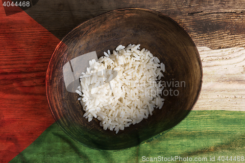 Image of Poverty concept, bowl of rice with Palestine flag      