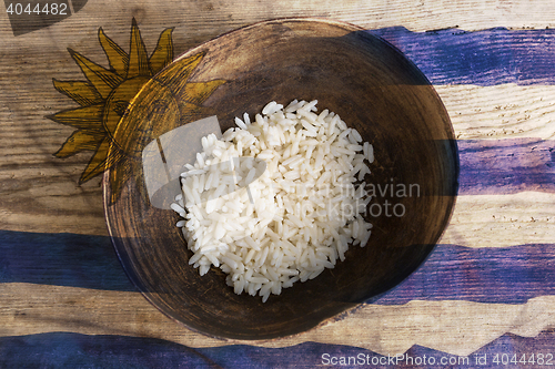 Image of Poverty concept, bowl of rice with Uruguayan flag      