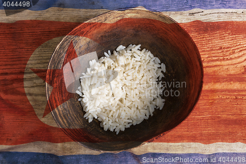 Image of Poverty concept, bowl of rice with North Korea flag      