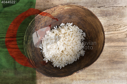 Image of Poverty concept, bowl of rice with Algeria flag      