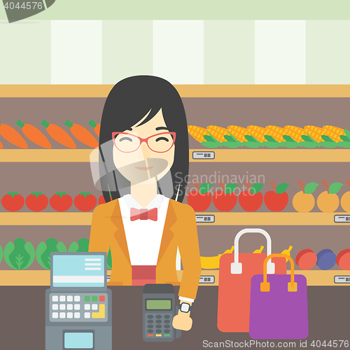 Image of Woman paying wireless with smart watch.