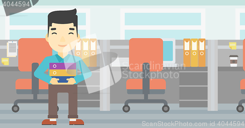 Image of Businessman holding pile of folders.